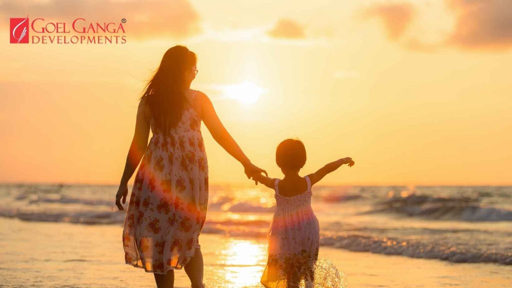 Mother and daughter discussing property investment at a premium residential project by Goel Ganga Developments