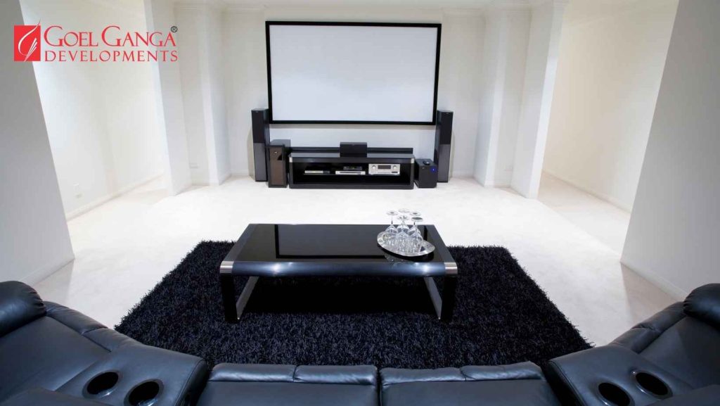 Experiential Living - home cinema interior featuring fiber-optic star ceiling and custom Dolby Atmos surround sound system in a premium property by Goel Ganga Developments."