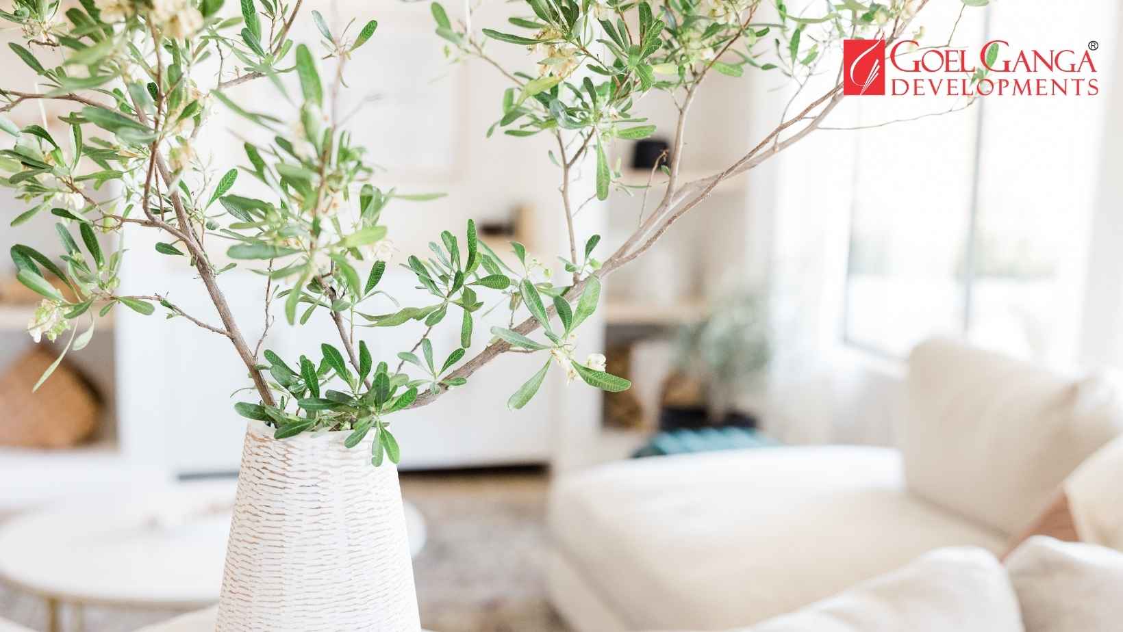 Modern eco-luxury residential apartment building by Goel Ganga Developments in Pune featuring vertical gardens, cascading green balconies, solar panels, and wide pedestrian walking trails.